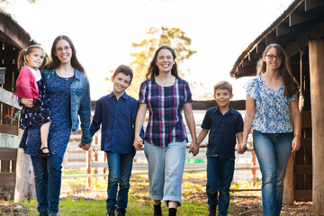 Group of different aged kids holding hands and walking