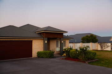Front entrance and driveway of a house at dusk