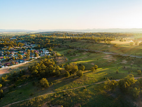 Edge of singleton, rolling hills and train track in afternoon light