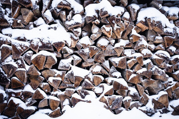 Pile of wood covered in snow