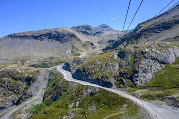 Hiking near ski station Les deux Alpes and view on Alpine mountains peaks in summer, Isere, France