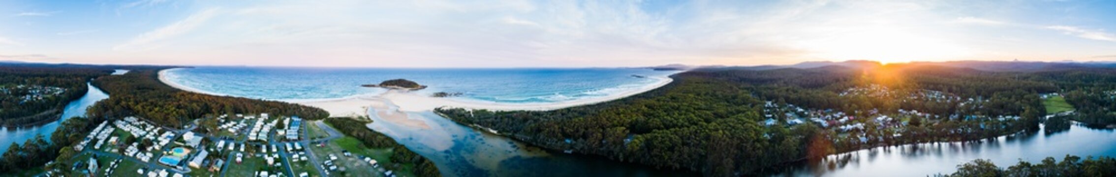 Coastal sunset over holiday caravan park and seaside view of beach and river mouth - crampton island
