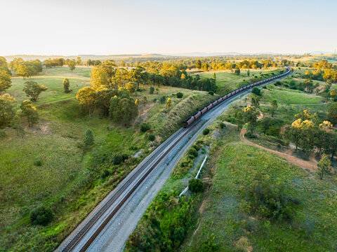 Coal train off in the distance along the railway tracks