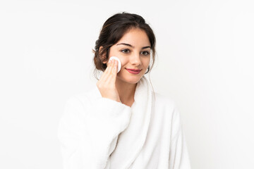 Young caucasian woman isolated on white background with cotton pad for removing makeup from her face
