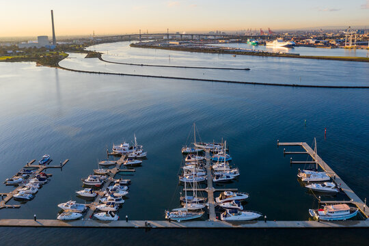 Aerial view of boats and yachts moored along jetties on a calm bay