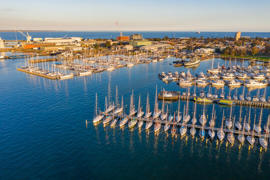 Aerial view of rows of yachts at a bay side boat club.