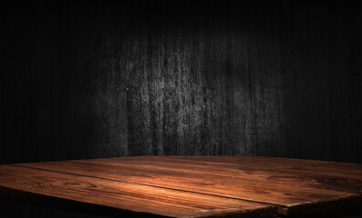 Selected focus empty brown wooden table and wall texture or old black brick wall blur background...