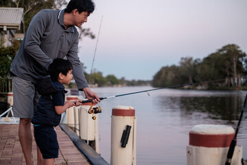 a curious kid being taught how to fish