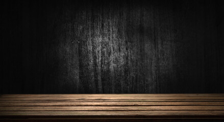 Selected focus empty brown wooden table and wall texture or old black brick wall blur background...