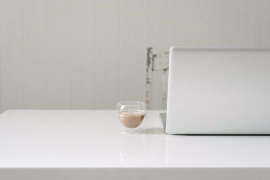 Clean White Desk With Laptop And Coffee And Copy Space