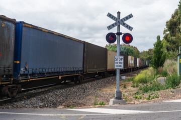 Freight train going through level crossing