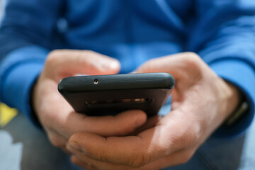 Close up view of a Guy while using smartphone,cellphone tech addiction 