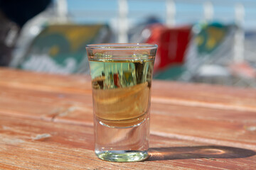 Tasting of very sweet french green strong liqueur based on many herbs, plants and flowers from Chartreuse abbey in Alpine mountains