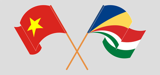 Crossed and waving flags of Vietnam and Seychelles