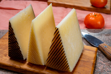 Cheese collection, pieces of hard Spanish manchego curado, viejo and iberico cheeses