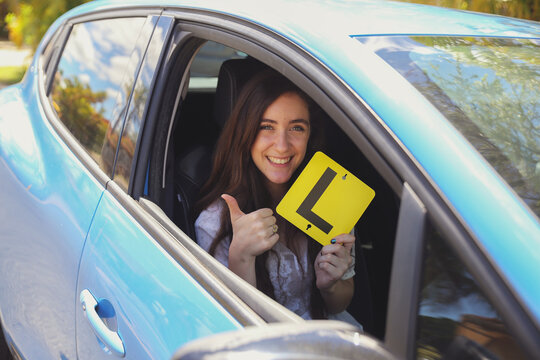 Teenage girl holding L plate