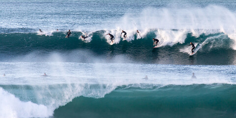 Group of surfers on a wave
