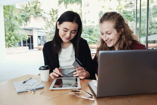 Young Business Women Having Casual Meeting At Coffee Shop