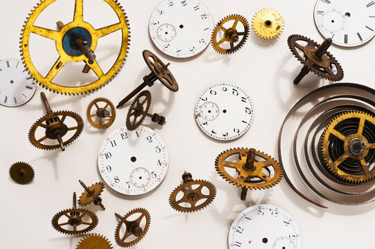 Close up of gears and clock parts on white background