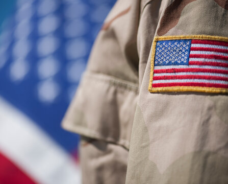 Close-up of badge with American flag on US military uniform