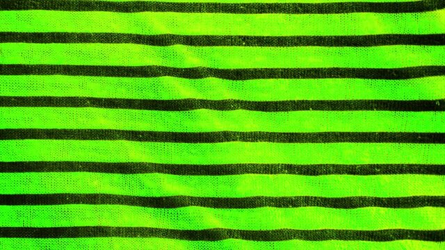 Black and green striped pattern texture background. Linen cotton macro shot, decorative woven.