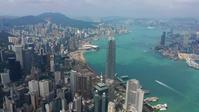 sunny day flight over hong kong cityscape downtown victoria harbour traffic aerial panorama 4k
