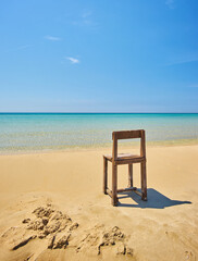 Lonely Old wooden chair on beach