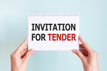 INVITATION FOR TENDER word inscription on white card paper sheet in hands of a woman. Business concept