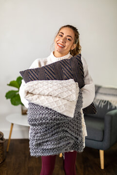 Woman Holds Blanket and Pillows