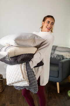 Woman Holds Blanket and Pillows