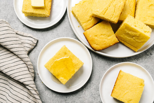 Golden cornbread squares topped with butter or honey
