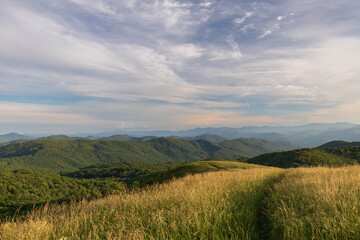 Trail at sunset, view from Max Patch bald over the Great Smoky Mountains