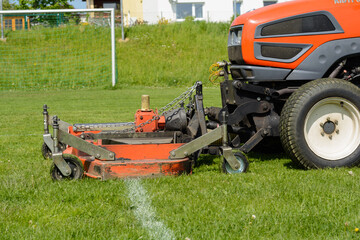 Obraz premium Sports Facility Is Mowed Lawn Tractor - Lawn Maintenance