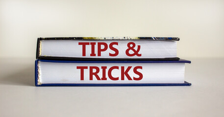 Tips and tricks symbol. Books with words 'Tips and tricks'. Beautiful white background. Business, tips and tricks concept. Copy space.