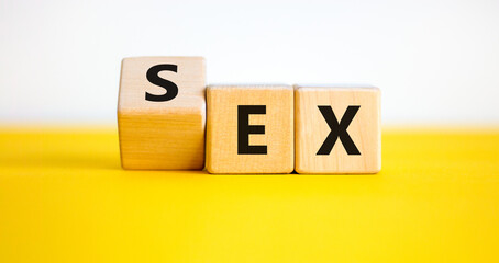 Sex with an Ex symbol. Turned a cube and changed the word 'ex' to 'sex'. Beautiful yellow table, white background. Psychology and Sex with an Ex concept. Copy space.