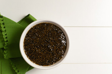Chia seeds appetizer with soy sauce and nori seaweed on a green napkin on a white background. Vegetarian food concept. Superfood. Top view. Copy space.