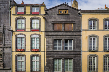 Fototapeta na wymiar typical facades built with volcanic stones in the clock tower street (Rue de l'horloge), in Riom, a small town in Auvergne (France)