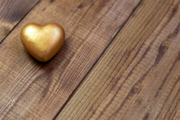 golden heart on a wooden background