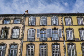 Typical colorful facades with volcanic stones in the Rue du Commerce in Riom, a small town of Auvergne (France)
