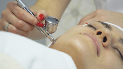 Face of woman having oxygen facial treatment in beauty salon