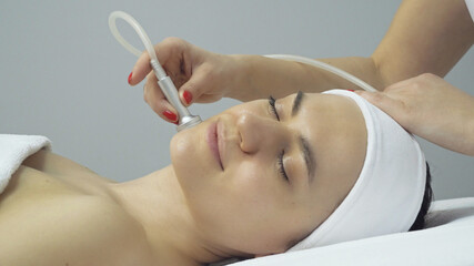 Face of woman having oxygen facial treatment in beauty salon