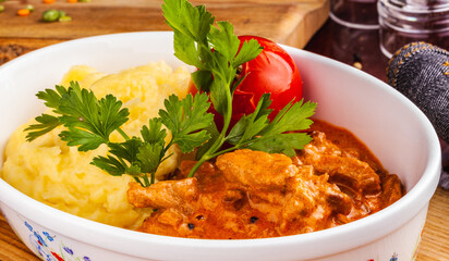 Beef Stroganoff with mashed potatoes in white bowl