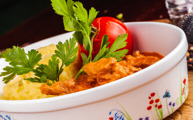 Beef Stroganoff with mashed potatoes in white bowl