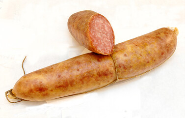 Ciauscolo is a spreadable salami sausage typical of the Marche region in Italy isolated on a white...
