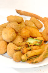 Mixed fried all'ascolana includes olives all'ascolana, artichokes, courgettes, lamb cutlets and fried cream.