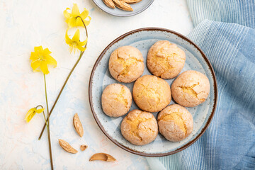 Almond cookies and a cup of coffee on a white concrete background Top view, close up.