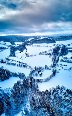Fototapeta na wymiar Beautiful panoramic aerial drone view on a winter landscape in the Stolowe mountains during a snowfall. The Stolowe Mountains National Park, Poland, Europe