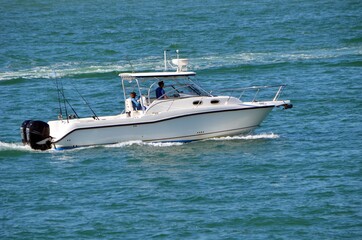 Well appointed sport fishing boat powered by two outboard engines cruising on Biscayne Bay near Miami Beach,Florida.