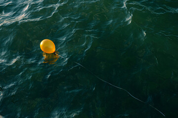 yellow balloon in the ocean
