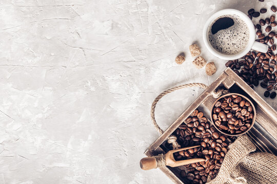 Coffee with  coffee beans on grey textured background. Top view with copy space. Background with free text space.